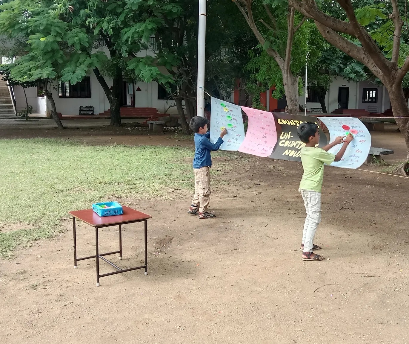 A thoughtful Grade 3 pupil contemplates the correct quantifiers to use in a fill-in-the-blank grammar worksheet in Salem's best CBSE school.