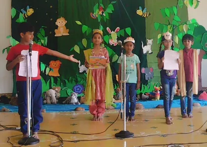 Grade 3A - Closet drama 3_result Vidhya Peetham i-School 3rd graders practicing their skits for children in the classroom with microphones, showcasing their developing public speaking skills.