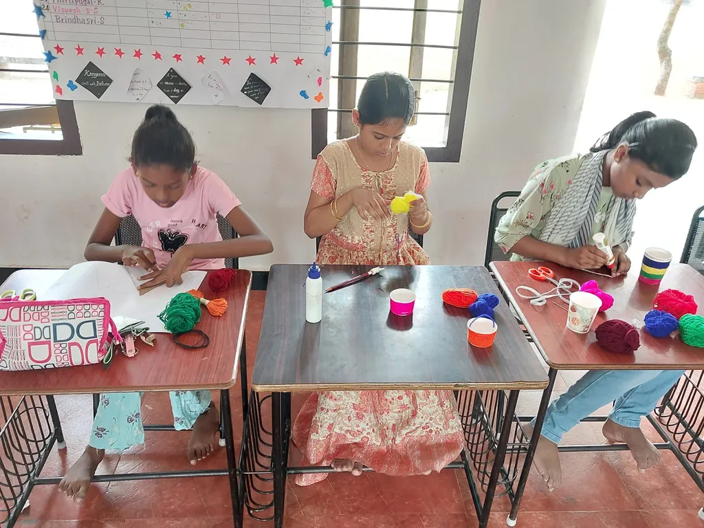 Dedicated young artists from Vidhya Peetham i-School applying glue to chart paper as they create yarn art, showcasing the vibrant educational activities available at Salem's best school.