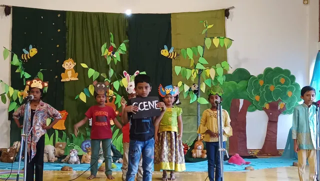 Handmade props including a golden egg and a cardboard axe, used in the Jataka Tales skit by 2nd graders, reflecting the creative education at a leading school in Salem.