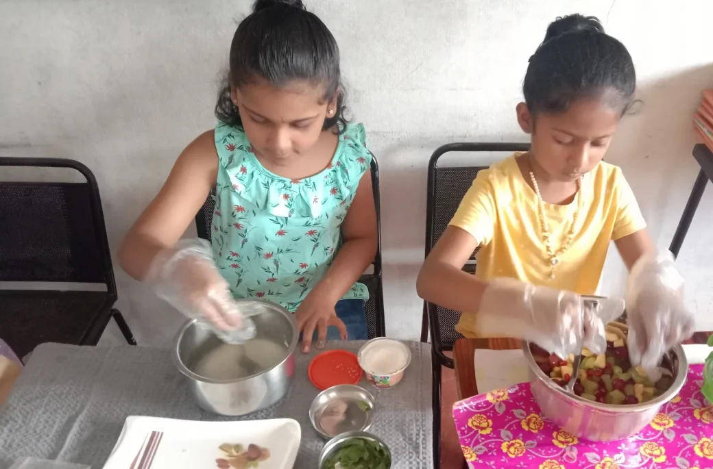 Third graders at Vidhya Peetham i-School in Salem concentrating on preparing raw foods dishes, showcasing their independence and following flameless cooking instructions.