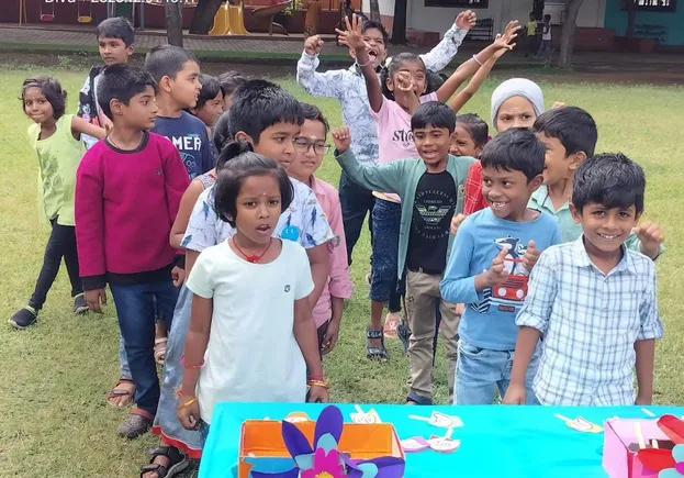 Group of young learners gathered around a Tamil spelling activity table, showcasing teamwork and engagement at a top school in Salem.