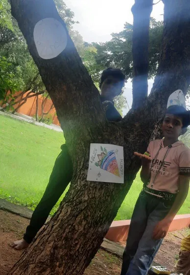 reative learning in action as students attach educational Earth diagrams to a tree in the school playground of a Salem CBSE school.