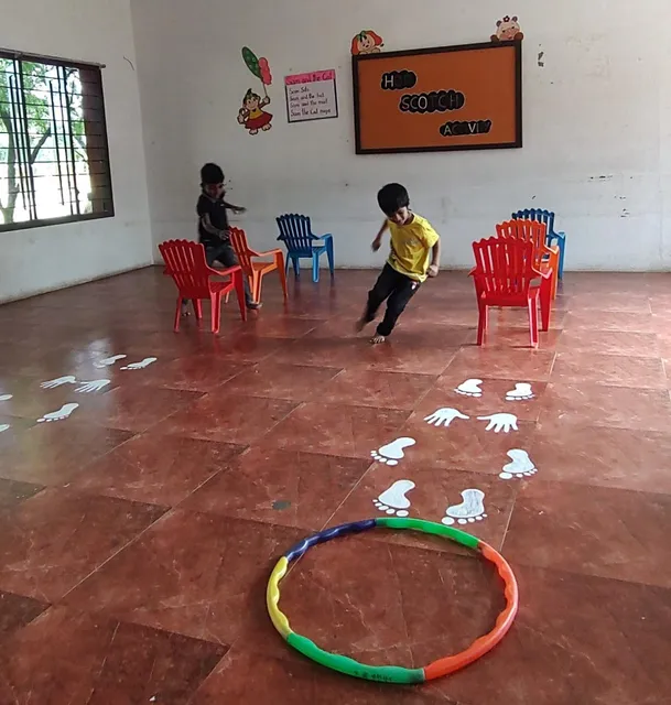 Students at Vidhya Peetham i-School, Salem, demonstrate hand-eye coordination in a hopscotch session.