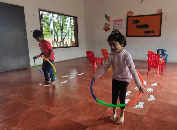 Boys and girls at a leading CBSE school in Salem participate in a hopscotch activity, promoting teamwork and cognitive development.