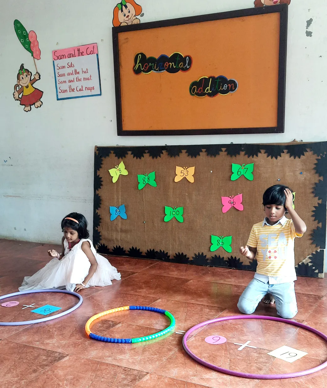 UKG Horizontal addition 2_result Kids at Vidhya Peetham i-School, the best CBSE school in Salem, enjoying a hands-on addition lesson with vibrant hula hoops and butterfly cut-outs.