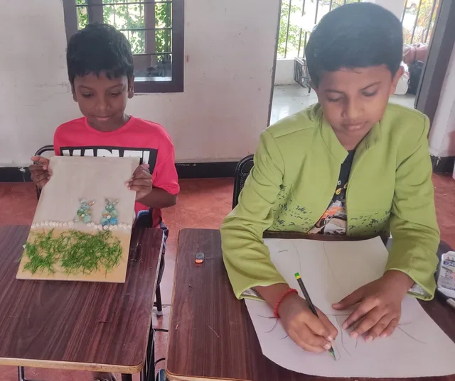 Eager students at Vidhya Peetham i-School sorting through a vibrant collection of pebbles for their art project.