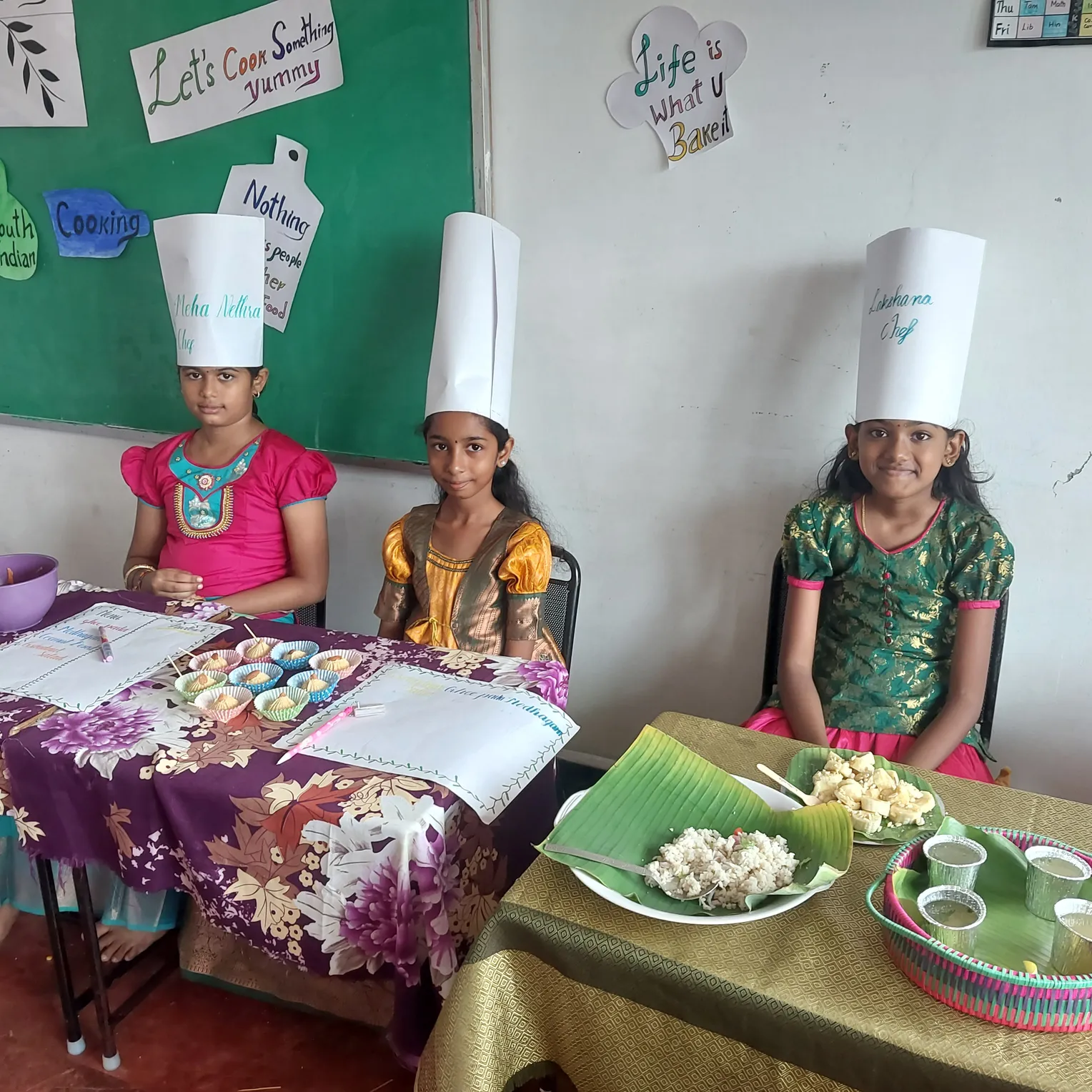 Aspiring culinary artists display their homemade South Indian sweets and snacks during a school event.