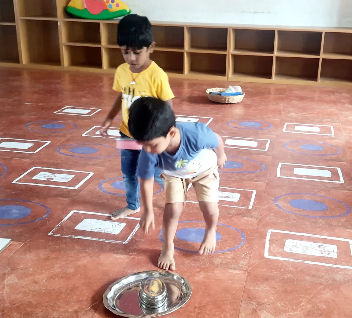 Pre-KG students at Vidhya Peetham i-School learning about rectangles and ovals through a dynamic floor game. ??
