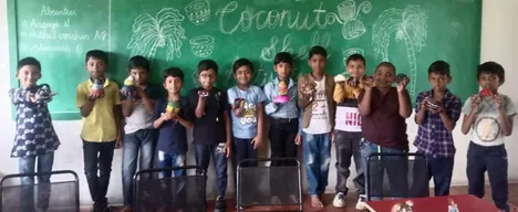 Group of students showing off their creative coconut shell art projects in a Salem classroom.