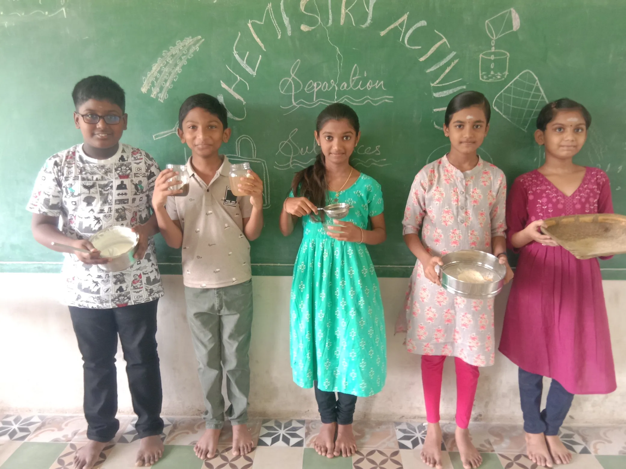 Kids performing sedimentation and decantation in an outdoor setting.