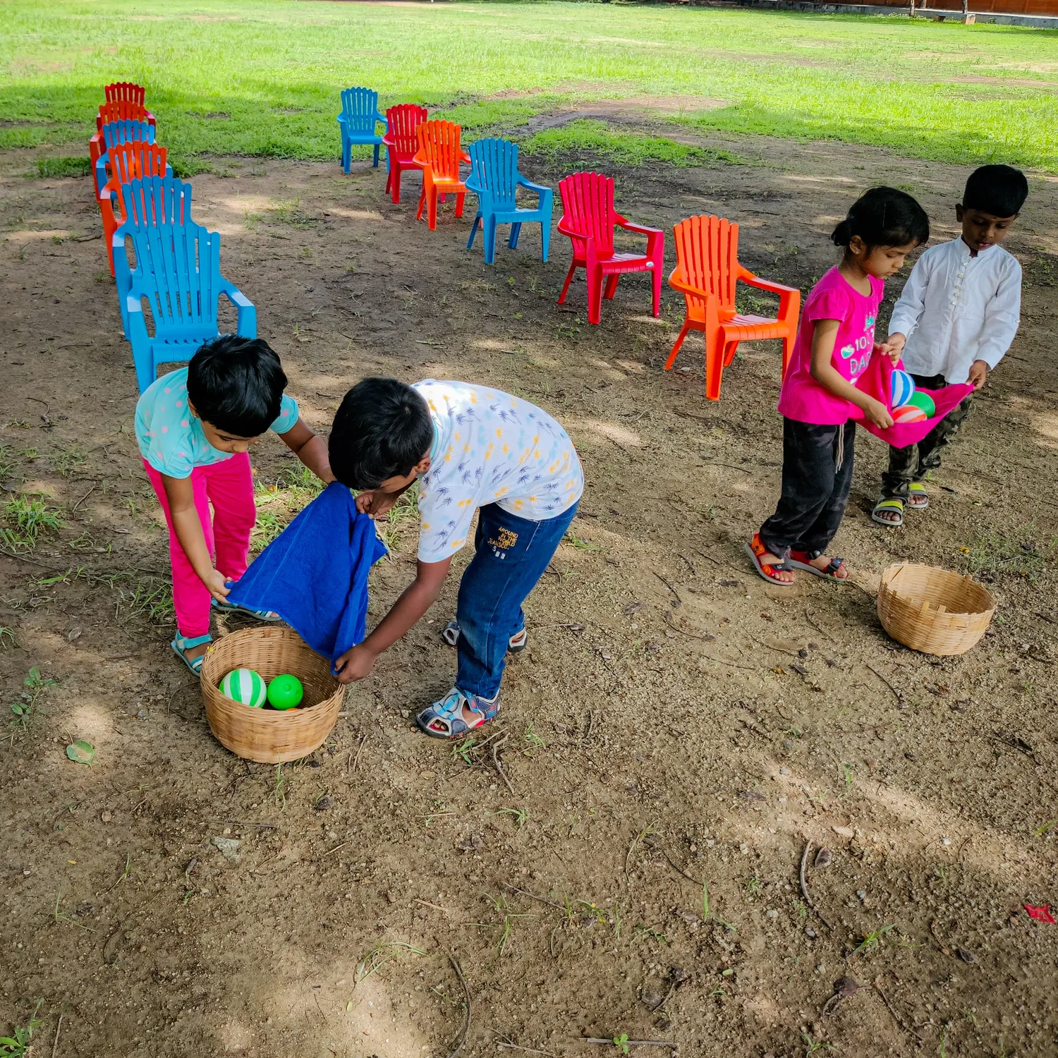 LKG students at Vidhya Peetham i-School engaging in a ball balancing activity to enhance teamwork and gross motor skills.