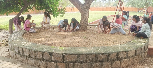 IMG_20240818_070838_copy_600x268 Group of students seated in a circle, measuring and calculating circumferences as part of a math activity in Salem.