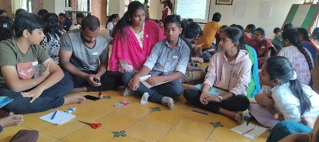 Students discussing leadership concepts in a group activity during the Basics of Electronics workshop.