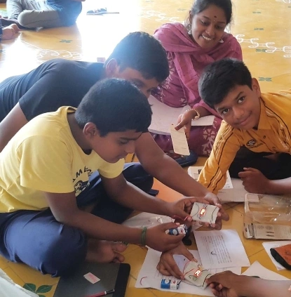 A group of students connecting circuits on a breadboard during a hands-on session at a Salem CBSE school.