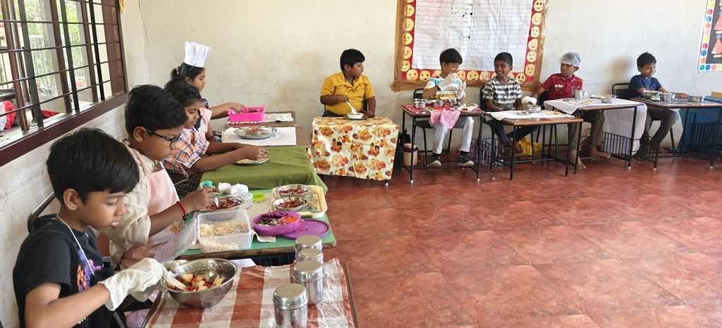 Proud grade 3 students presenting their culinary creations during the culinary arts workshop