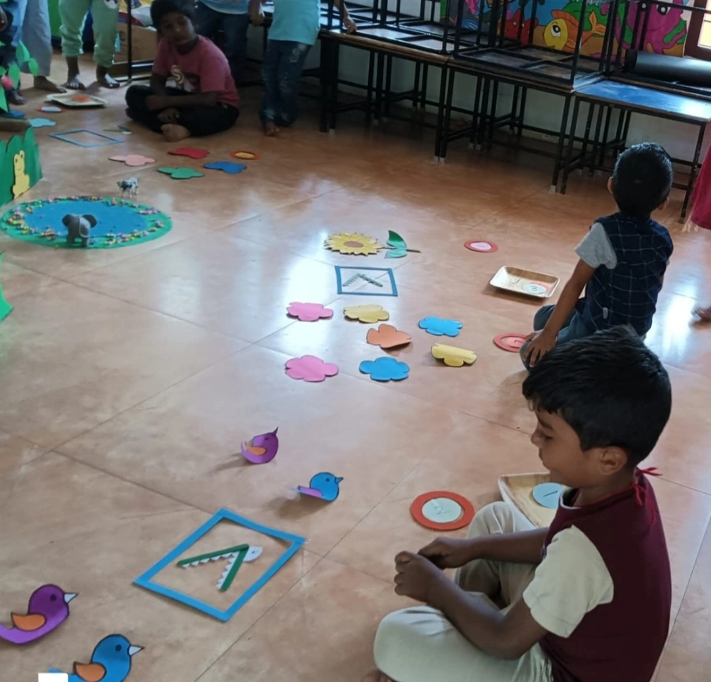 Student demonstrating understanding of bigger number concept with crocodile mouth sign