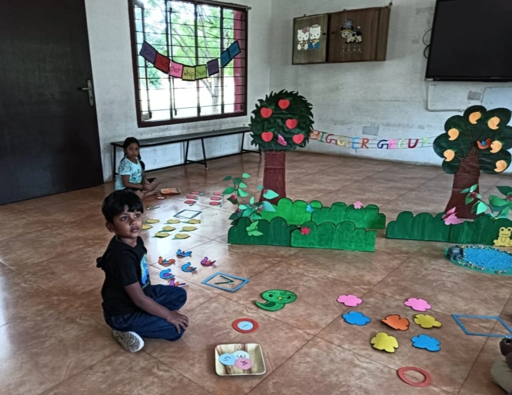 Children learning mathematics through interactive garden setup with birds and number circles