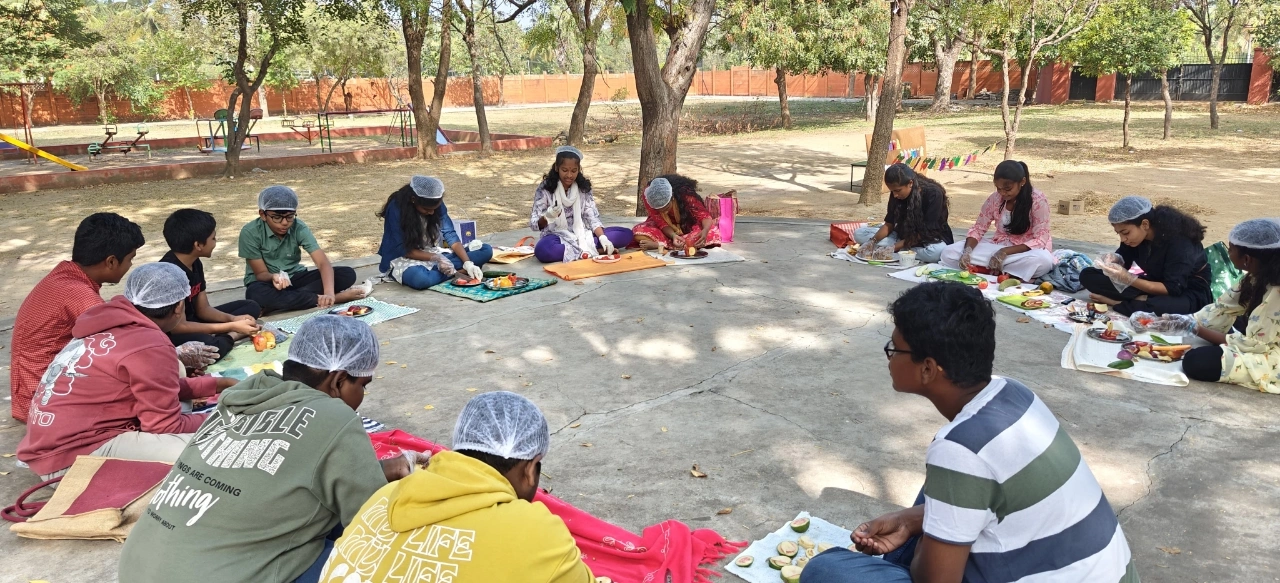 Panoramic view of fruit carving class under trees at top schools in Salem