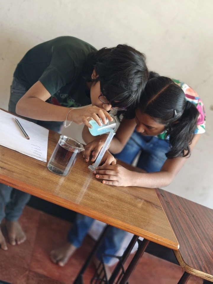 Students conducting liquid volume experiment