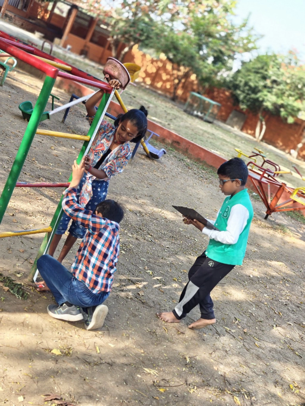 Grade 3 students measuring playground equipment during math activity