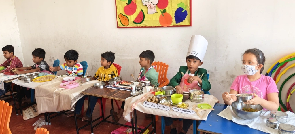 Students focused on preparing healthy dishes using fresh ingredients in their cooking stations