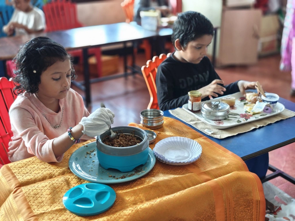 Students engaged in flameless cooking activity, working independently at their designated stations