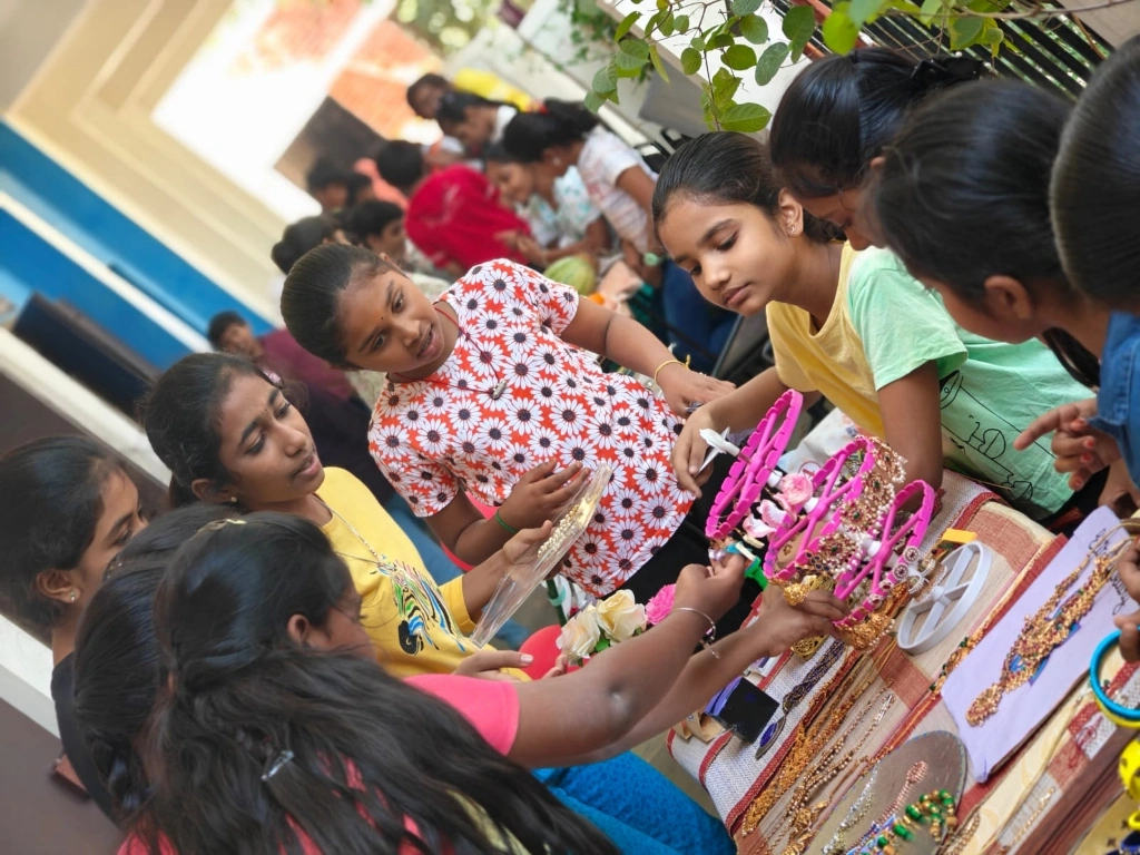 Young entrepreneurs showcasing handmade jewelry and accessories at the school's math market