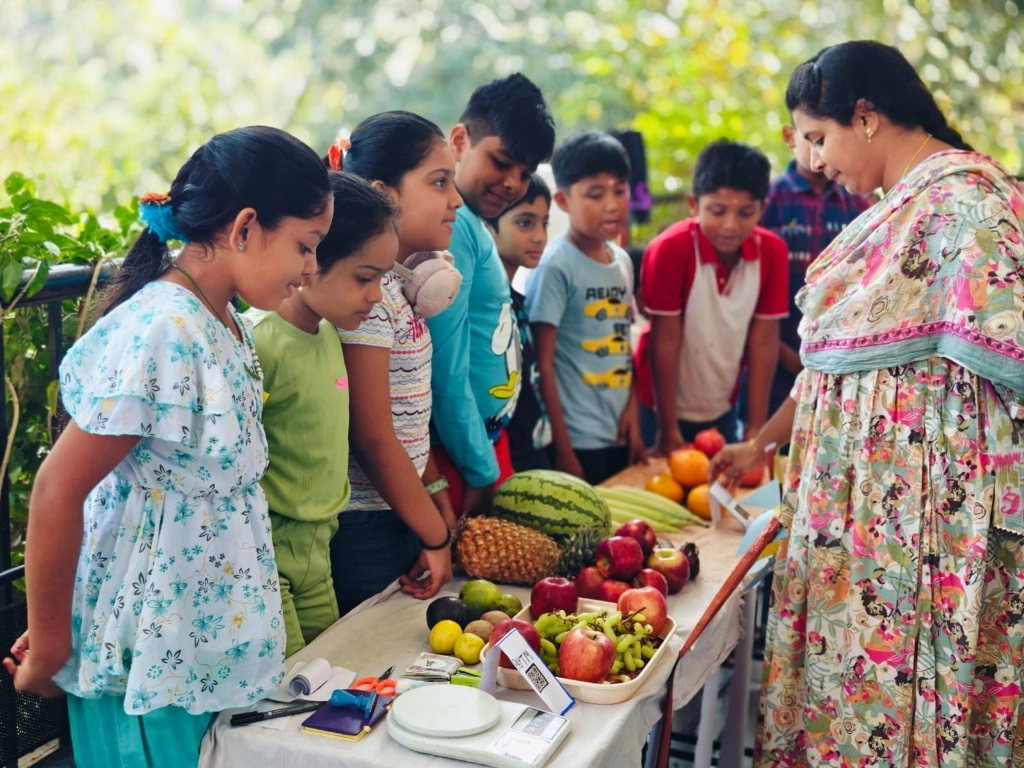 Students practicing real-world math with fresh fruit pricing activity while learning about profit and loss