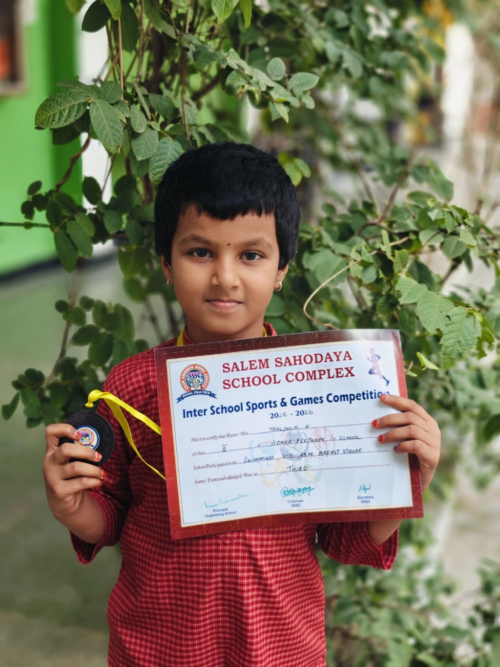 Grade 2 student Yaalnila with bronze medal from Salem Sahodaya swimming competition at best school in Salem