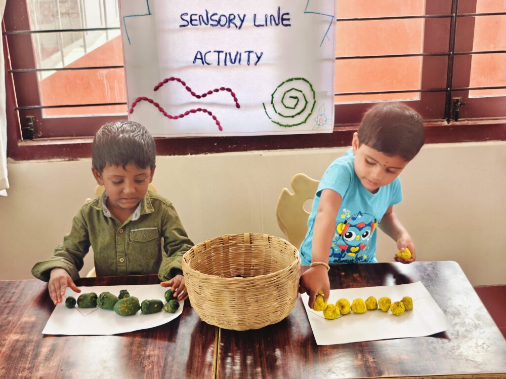 Two children arrange green and yellow pieces along lines on either side of a woven basket.